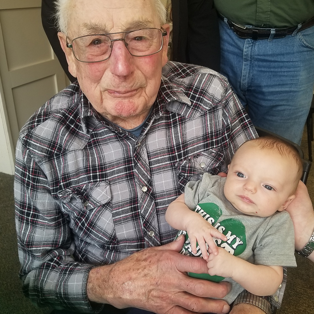 Photo of Grandpa Holding Baby In Dementia and Alzheimer Assisted Living  Home