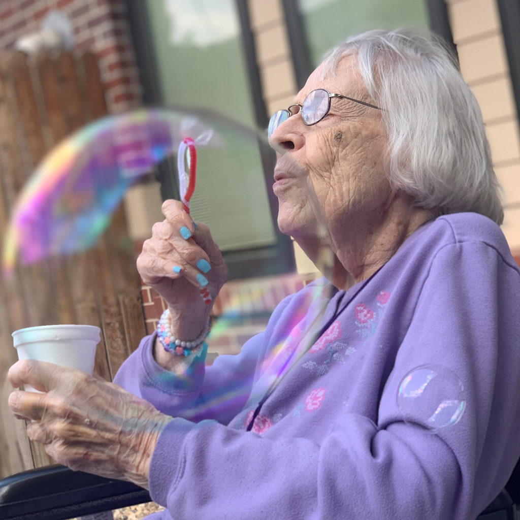 Lincoln Assisted Living & Memory Care Blowing Bubbles Photo